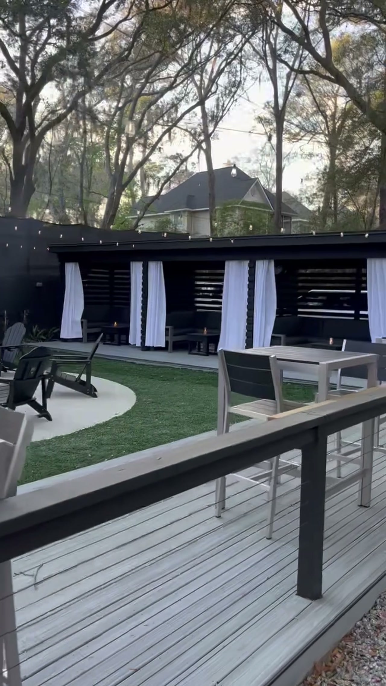 Outdoor deck with bar seating under string lights